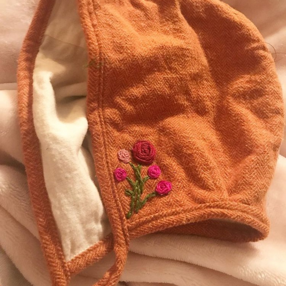 Joyfully stitched rust bonnet with embroidery